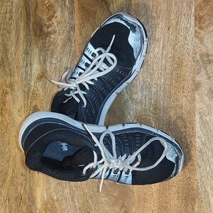 Black and white Under Armour kicks